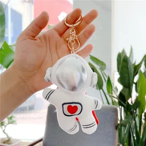 White astronaut plush keychain with silver helmet detail and red heart embroidery
