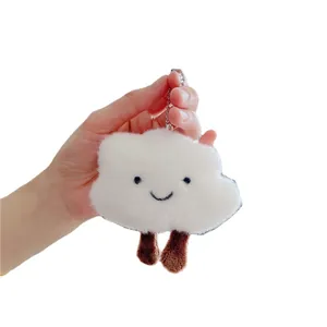 Cute white plush cloud keychain with embroidered smile and brown dangling legs