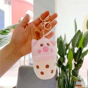 Detail of pink pig plush keychain in milk tea cup shape with soft embroidered features