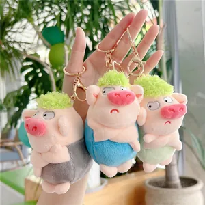 Three cute plush pig keychains with funny expressions and green fuzzy hair in pastel colors
