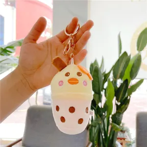 Detailed close-up of a plush milk tea cup pendant with cute cartoon duck features