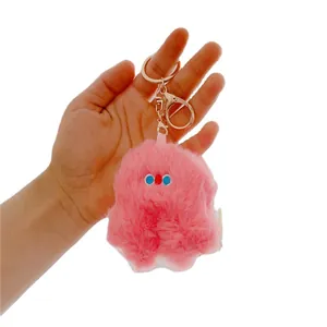 Cute pink plush monster keychain accessory with soft faux fur and golden metal ring