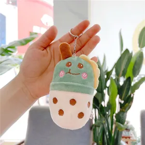 Close-up of a bubble tea plush keychain in matcha green and cream held in hand