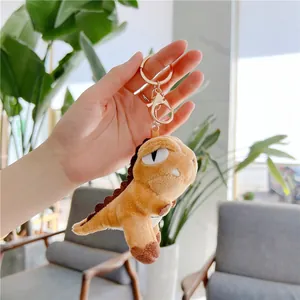 Cute plush T-Rex dinosaur keychain in brown with golden metal ring and lobster clasp