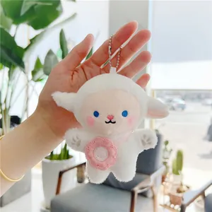 Close-up of white plush lamb keychain with pink flower and metal bead chain detail