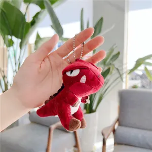 Detail of plush red Tyrannosaurus dinosaur keychain with soft texture and silver bead chain