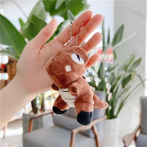 Close-up of brown plush dinosaur keychain with silver metal chain held in a hand