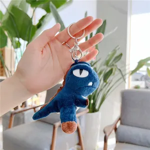 Detail of blue plush T-Rex keychain with soft fabric and silver metal lobster clasp