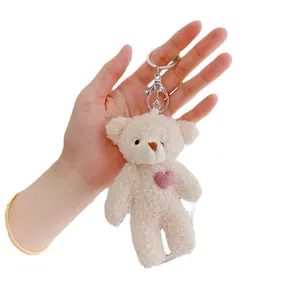 Mini cream teddy bear plush keychain with pink heart detail and silver metal clasp