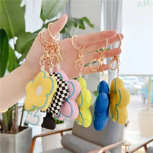 Chic fabric flower keychains with plush petals and gold metal clasps for bag charms