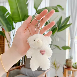 Plush white teddy bear keychain with pink heart detail and silver metal ring clip