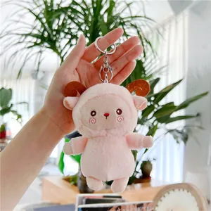 Pink plush sheep keychain with soft long fur and brown horns for bag decoration
