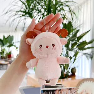Close-up of a soft pink plush sheep keychain with brown horns and a silver bead chain