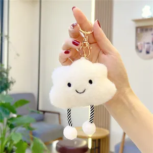 Cute white plush cloud keychain with smiling face and striped legs on a lobster clasp