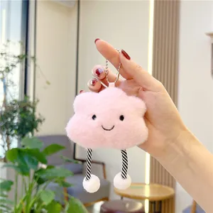 Detail of pink plush cloud keychain with striped legs and soft fluffy texture