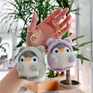 Cute penguin plush keychains in soft green and purple with golden metal rings