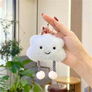 Detail of cute blue plush cloud keychain with long striped legs and silver bead chain