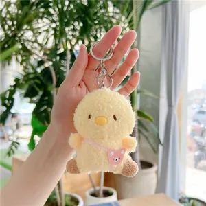 Detail of yellow plush chick pendant with pink bear bag and silver metal lobster clasp