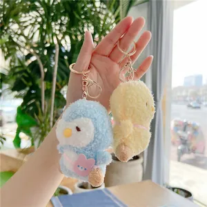 Plush yellow chick and blue penguin keychains with soft curly faux fur and gold clips
