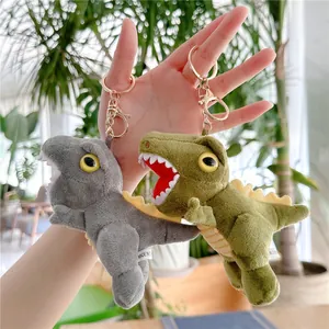 Cute plush dinosaur keychain in grey and green colors with gold metal clasp detail