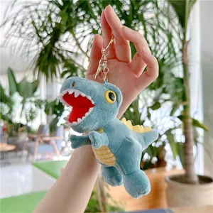 Detailed close-up of a blue plush dinosaur keychain with yellow stripes and metal ring