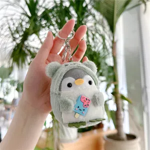 Close-up of green penguin plush keychain with blue ice cream and silver metal ring