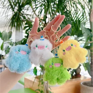 Plush monster keychain set in blue white green and yellow with gold metal ring hooks