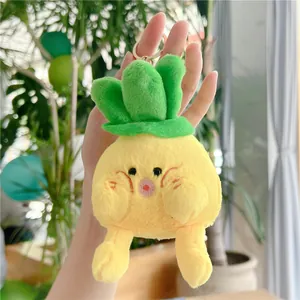 Cute pineapple plush keychain with yellow body and green leaves on a metal keyring