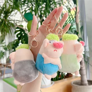 Three colorful plush pig keychain pendants in grey-blue, sky blue, and green colors