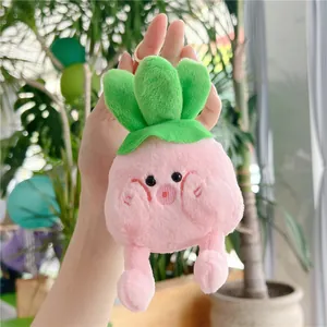 Close-up of a cute pink cabbage plush keychain with soft legs and green leaves