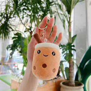 Close-up of a plush bubble tea keychain with cute smiling face and golden metal ring