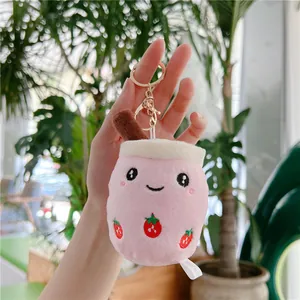Cute pink bubble tea plush keychain with strawberry pattern and gold metal clasp