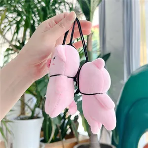 Close-up of two cute pink plush pig charms with elastic cords for bags and keys