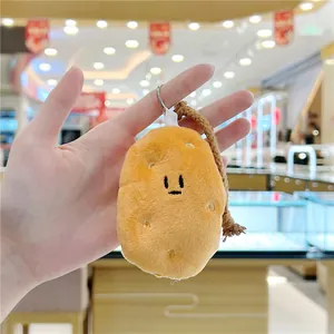 Close-up of cute plush potato keychain with silver metal ring and woven rope detail