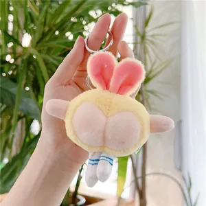 Detail of creative yellow plush bunny keychain with peach-shaped bottom and striped socks