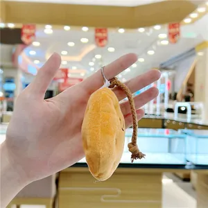 Detail view of plush potato keychain with yellow soft texture and durable metal ring