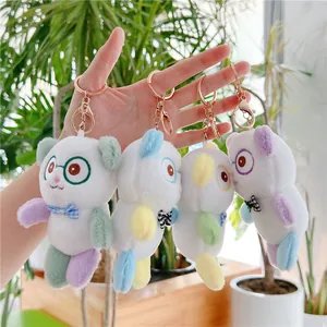 Cute panda plush keychain with colorful limbs and bow ties in a bright outdoor setting