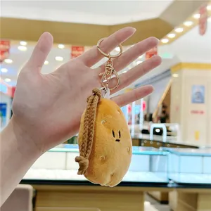 Cute cartoon potato plush keychain with gold lobster clasp and brown woven strap
