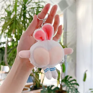 Detail of funny white bunny plush keychain featuring peach butt design and striped socks