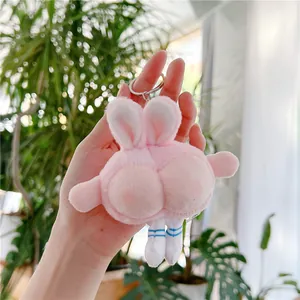 Detailed close-up of a funny pink bunny butt plush keychain with cute striped socks