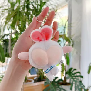 Funny white plush bunny keychain featuring a pink peach butt design and blue striped legs