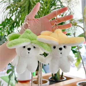 Cute cartoon banana dog plush keychain in green and yellow displayed in natural light