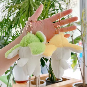 Cute cartoon banana dog plush keychain in white with green and yellow accents