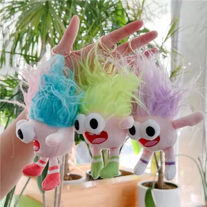 Plush monster dolls with big eyes and colorful hair in blue, yellow and purple styles