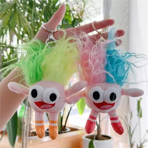 Detailed view of colorful plush dolls featuring fuzzy hair and striped legs on keychains