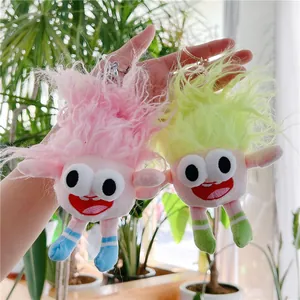 Close-up of colorful fuzzy troll plush keychains with wild hair and big eyes