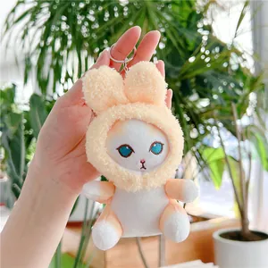 Close-up of cute plush bunny-eared kitten keychain with metal ring and soft texture