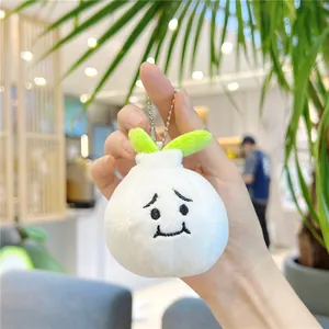 Close-up of cute garlic plush keychain with embroidered expression and silver bead chain