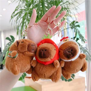 Three cute Capybara plush keychains with strawberry and chicken hat accessories