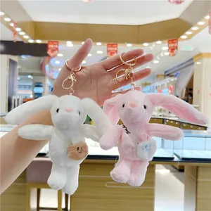 Cute long-eared plush bunny keychains in pink and white with mini bags and metal hooks